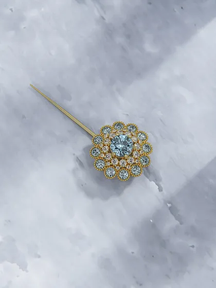 Another view of the aquamarine and diamond floral pin, showing its sparkle from a different angle. It is made to feel like it has always been yours.