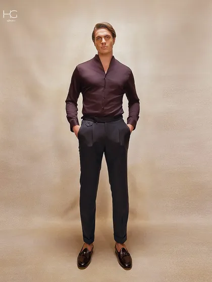 A full-length view of the burgundy shirt paired with dark tailored trousers. This combination creates a look of deep, understated luxury.