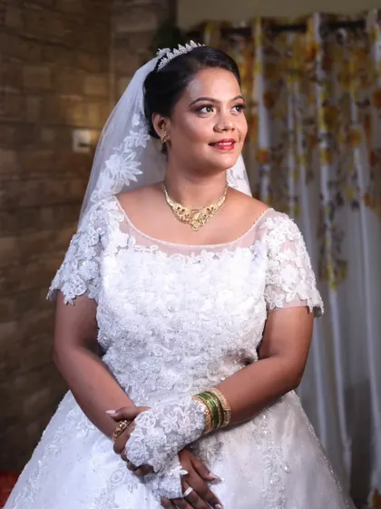 Simple glam for this beautiful bride. Her makeup features a soft smokey eye and a warm nude lip, paired with a classic updo and tiara for a look that is both modern and princess-like.