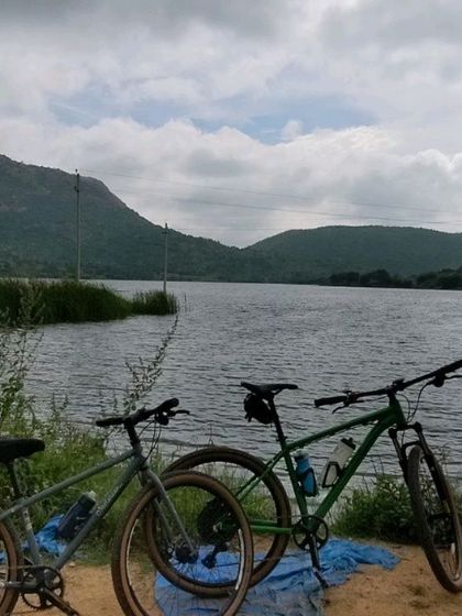 Two bikes resting by a serene lake. A simple, perfect moment from one of our weekend rides.