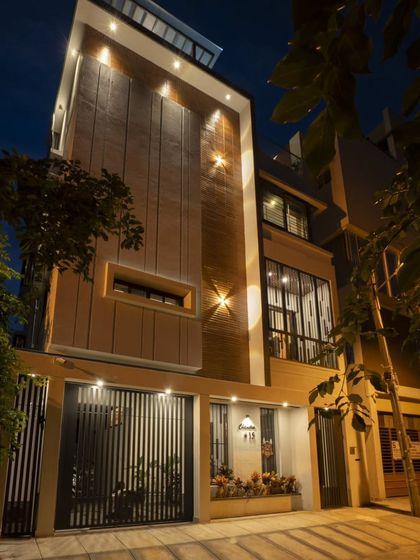 The Banashankari residence at night. The facade lighting is designed to be subtle, accentuating the brick texture and the clean lines of the structure, proving that even on a small plot, a home can have a powerful architectural identity.