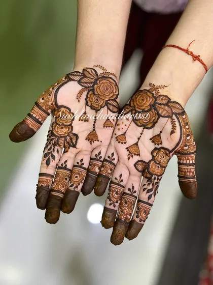 For those who love a lighter, more modern look. This design features beautiful floral vines with delicate jhumka (earring) details, giving it a jewelry-like feel.
