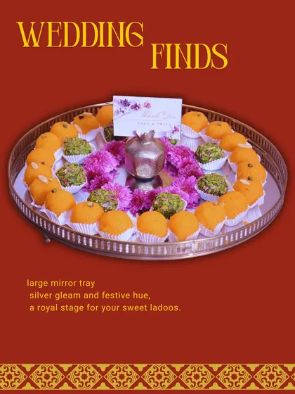 A large mirror tray serving as a royal stage for your sweet laddoos. The reflective surface and elegant design make it a standout piece for serving mithai at weddings.