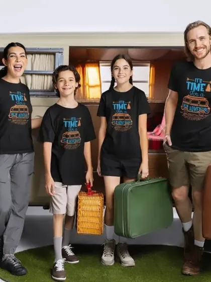 Adventure is calling. This family is ready for a road trip with their matching black tees, complete with vintage suitcases and a camper van backdrop.