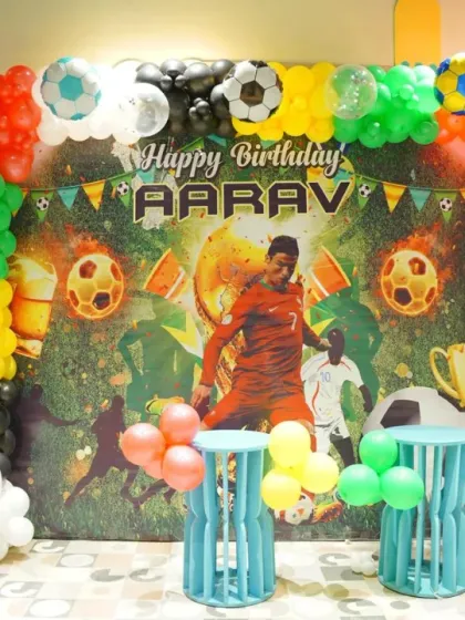 It's a goal! This football-themed birthday setup is perfect for a sports-loving kid. With a dynamic backdrop and soccer ball balloons, we bring the excitement of the game to the party.