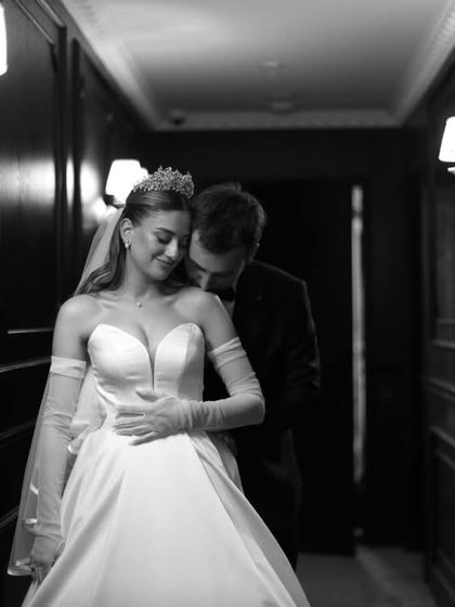 An intimate moment in a quiet hallway. This black and white portrait captures the tender connection between a bride and groom, a silent promise of the lifetime ahead.