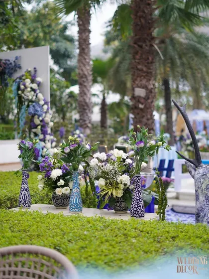 Another view of the floral arrangements scattered throughout the venue's lush green spaces, seamlessly blending the decor with the natural environment.