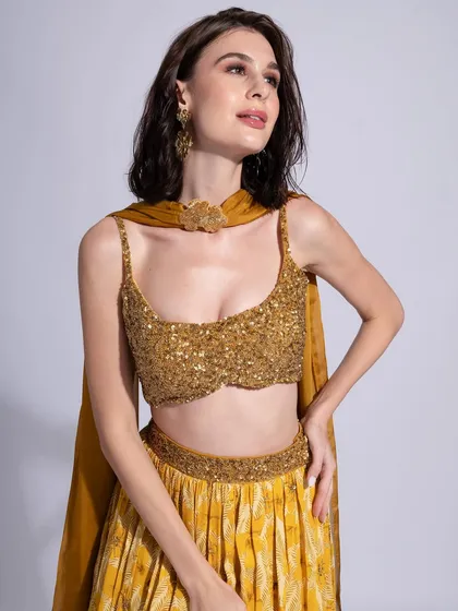 A glamorous golden look for Label Shivani Nirupam. The makeup is bronzed and glowing to complement the sequined top.