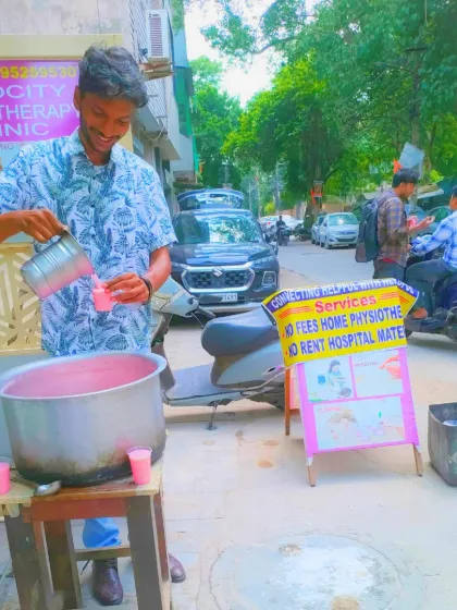 Our Chabeel stall is set up to serve everyone. You can see our *Sachi Sewa* board in the background, which also offers information about our free home physiotherapy services for those in need.