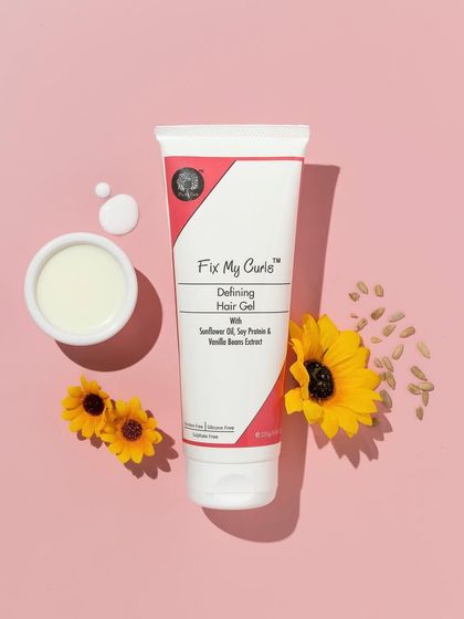 A clean and simple flatlay that highlights the product and its natural ingredients. The arrangement of the hair gel with sunflowers and seeds is both beautiful and informative.