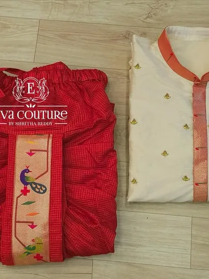 For little gentlemen, I offer traditional raw silk kurta sets. This one features subtle maggam work butties and is paired with a striking red Pattu dhoti that has a detailed Paithani border.