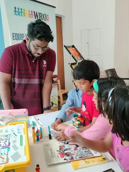An instructor engages with young children at our promotional event at Total Environment, Whitefield, giving them a hands-on taste of our fun learning activities.