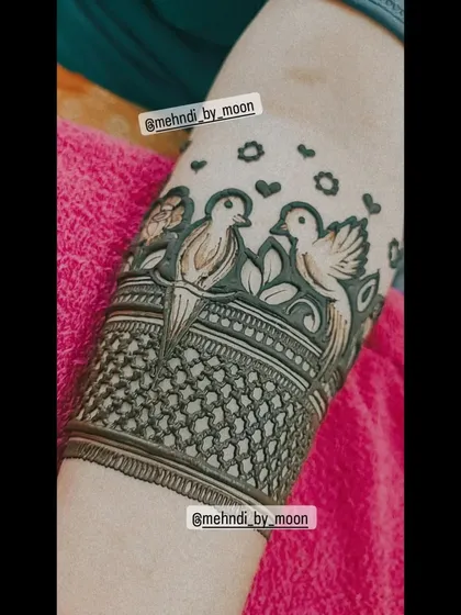 A close up of a love birds motif. This is a popular element to add to engagement or bridal mehndi, symbolizing the love and partnership of the couple.