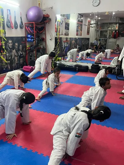 A class of young students practicing their stretches under my supervision. Flexibility is just as important as strength in martial arts.