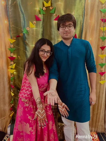 A lovely photo of the couple showcasing their matching initial mehendi. It's a beautiful way to connect through henna.