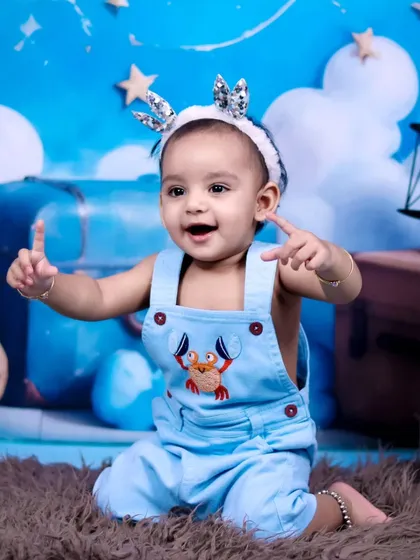 A joyful and expressive portrait of the birthday boy during his teddy bear themed session.