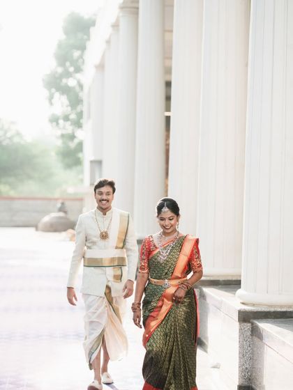 A candid shot of the couple walking together, capturing their natural interaction.