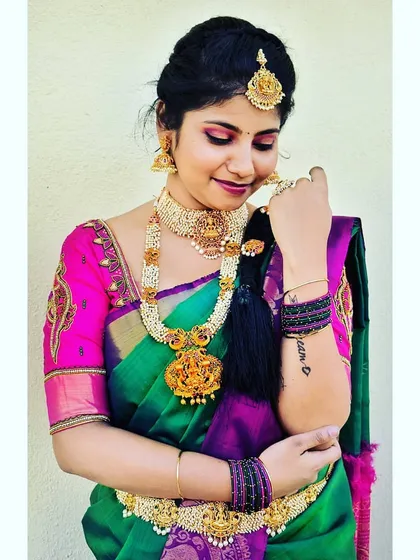 Another angle of this traditional look, showing how the makeup and accessories come together. The client's tattoo is visible, and we made sure the styling felt authentic to her.