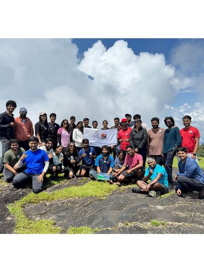 A group photo with the clouds as a backdrop. The weather on Kumara Parvatha can change in an instant, creating dramatic scenery.