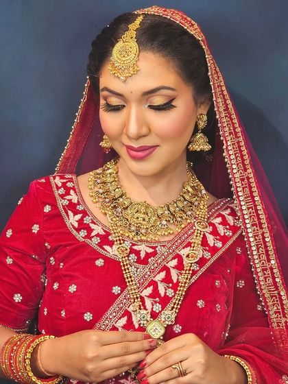A beautiful bridal portrait with eyes closed, highlighting the soft, blended eyeshadow and flawless base. This look is all about enhancing natural beauty with a touch of gold.