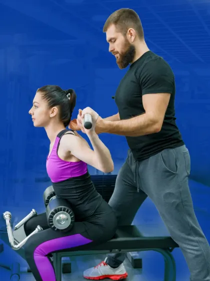 Perfecting your form is my top priority. Here, I'm guiding a client through a back exercise, ensuring her posture is correct to prevent injury and maximize muscle engagement.
