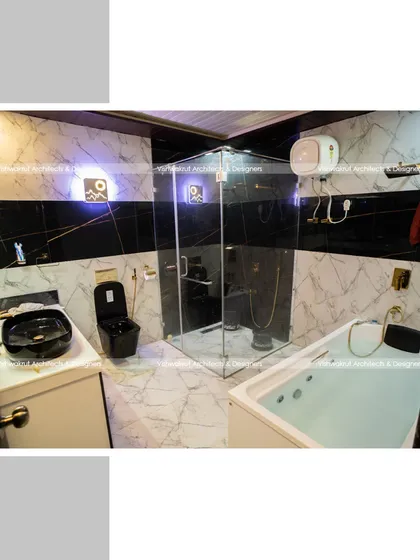 The master bathroom at Rock Villa, featuring a modern bathtub, a glass-enclosed shower, and a contrast of black and white marble-patterned tiles. This space was designed to provide a spa-like, luxurious experience.
