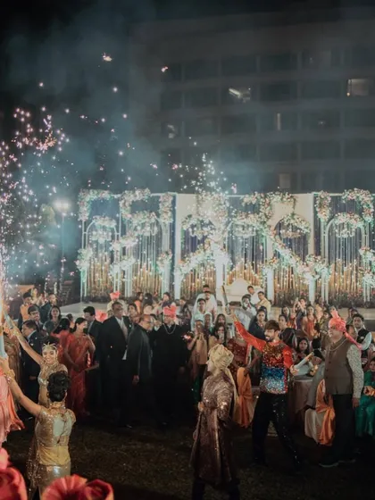The entire wedding party celebrates with sparklers as the couple makes their way through the crowd. I love creating these moments of collective joy that involve all the guests.