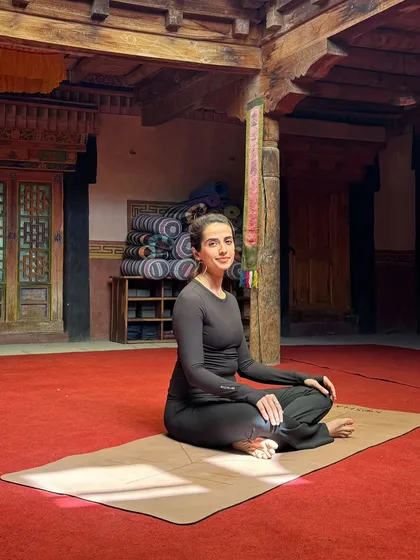 Seated in the beautiful, traditional yoga shala at Nimmu House, Ladakh. The space itself, with its vibrant colors and serene atmosphere, becomes a part of our practice.