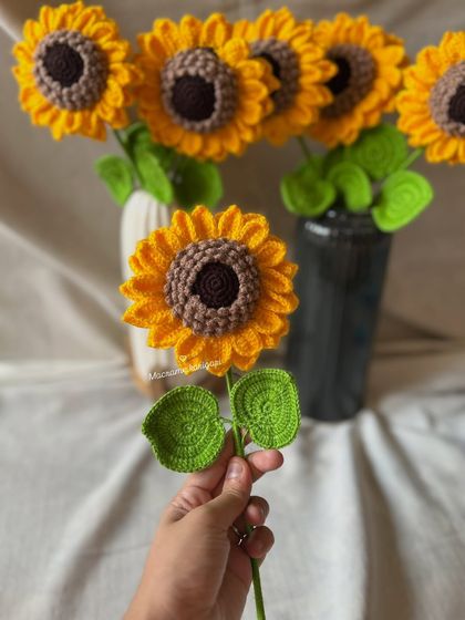 Holding one of our classic 3D crochet sunflowers. These are one of our bestsellers and are perfect for gifting a little bit of sunshine.