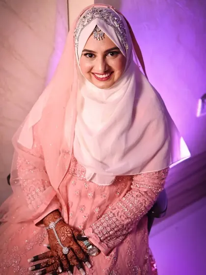 A lovely portrait of the bride-to-be in her pink engagement outfit. Her happy expression and elegant pose perfectly capture the joy of this new beginning.