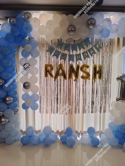 A blue and silver balloon frame with flower-shaped balloon clusters.