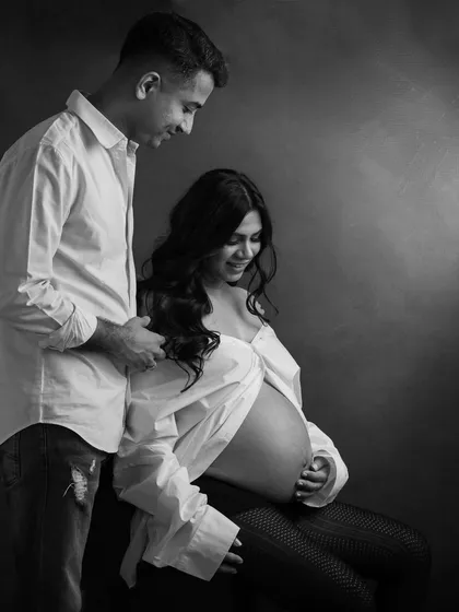 The shared smile and gentle touch in this black and white couple portrait speak volumes. It’s these small, real interactions that I love to capture.