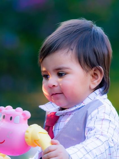 A close-up of a curious baby boy playing with his walker toy. I focus on capturing these simple, everyday moments of discovery and play.
