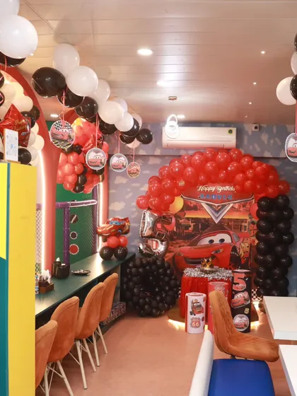 The entire party area is transformed for our Cars theme, with red and black balloons and themed decor creating an immersive experience for the birthday boy and his friends.