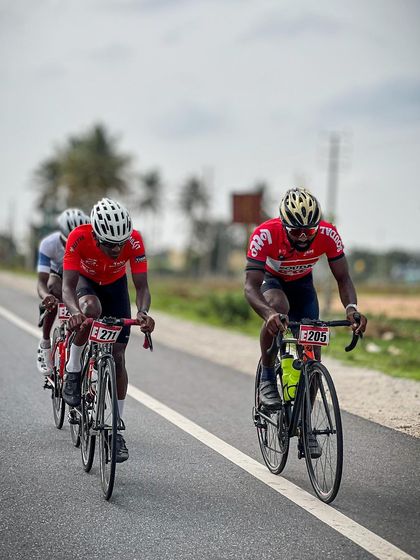 Two elite riders from the Cyclopedia academy, showing their team colors.
