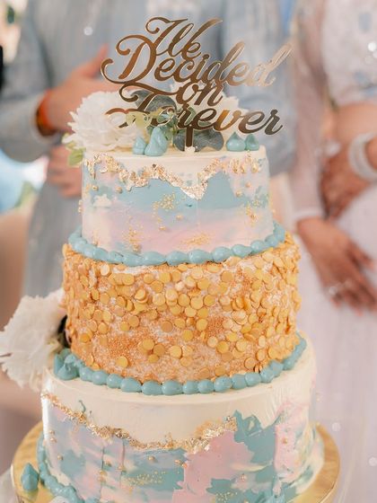 A beautiful three-tiered cake for Yash and Sakshi's Roka ceremony, with a topper that reads "We Decided on Forever." Every detail is planned to celebrate the couple's journey.