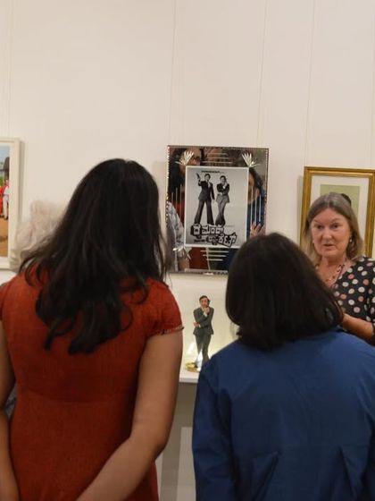 Clare Arni discussing a specific set of artworks with the visiting group from MAP.