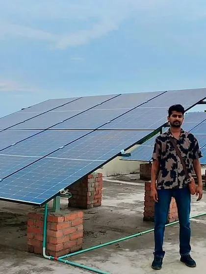 A wide shot of the rooftop solar panel installation at V.R. Public School. The panels are mounted on elevated structures to avoid shading and maximize sun exposure, ensuring optimal performance.