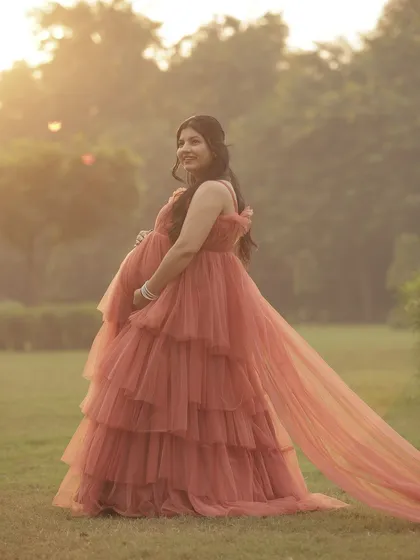 The golden hour light makes our coral gown look even more magical. This is a beautiful solo portrait of the glowing mother-to-be.