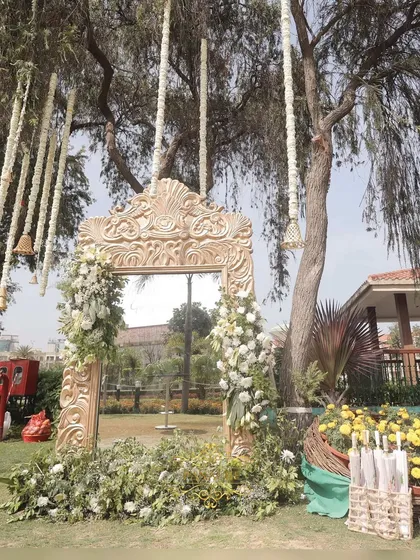 Another view of the golden mirror photo booth, set against the natural backdrop of the venue.