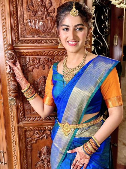 This bride's happiness is infectious. Her makeup look is all about a healthy glow, with rosy cheeks and a pretty pink lip that enhances her youthful charm.