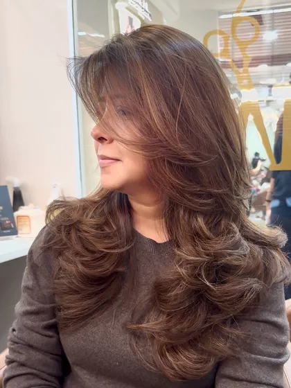 A perfect transformation featuring a new hair color and a fresh layered haircut. The combination creates a voluminous and stylish look.