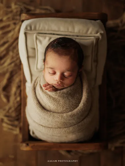 I believe in the beauty of simplicity. This is a classic newborn portrait, where your baby is safely wrapped and peacefully dreaming in a rustic, cozy bed. The earthy tones and soft textures create a serene atmosphere, letting your little one's perfect details shine.