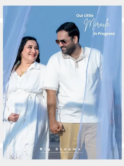 A happy couple holding hands during their outdoor maternity session. The bright blue sky and light, airy outfits give this portrait a fresh and joyful feel.