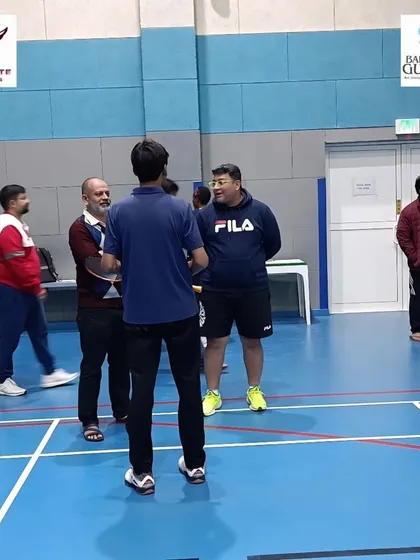 A senior coach from the Pullela Gopichand Academy interacting with adult players at a special coaching camp in Doha, Qatar.