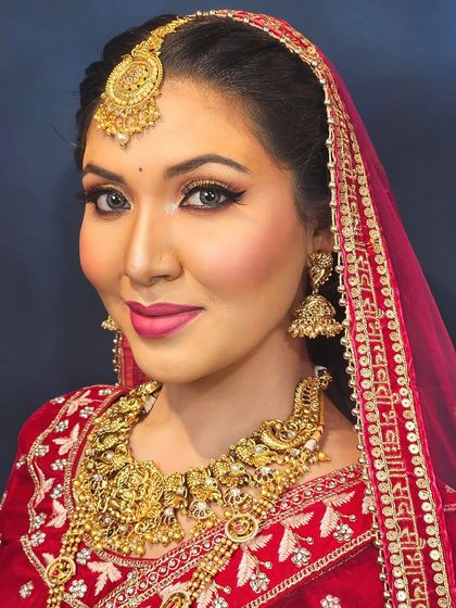 A confident bridal pose showing off the complete look. The winged eyeliner and perfectly defined brows frame the face, while the skin has a beautiful, healthy glow.