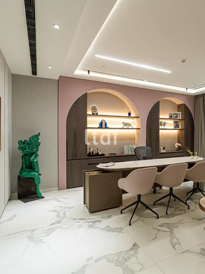 This modern office redefines the workspace with a fusion of texture, form, and color. We used soft pink arched niches, sleek finishes, and warm lighting to create a contemporary aesthetic that is both professional and deeply personal.