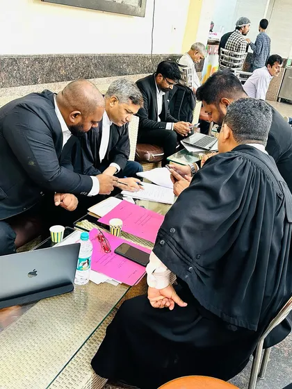 Deep in discussion, analyzing every aspect of the case with senior advocates.