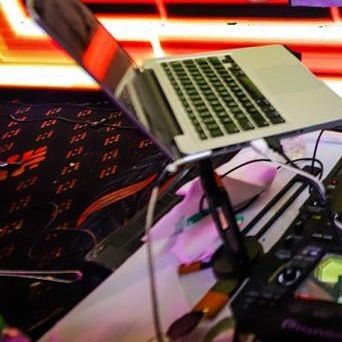 My laptop and console, the tools of my trade, ready for action against a vibrant LED background.