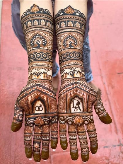 A personalized bridal design with initials and peacocks.